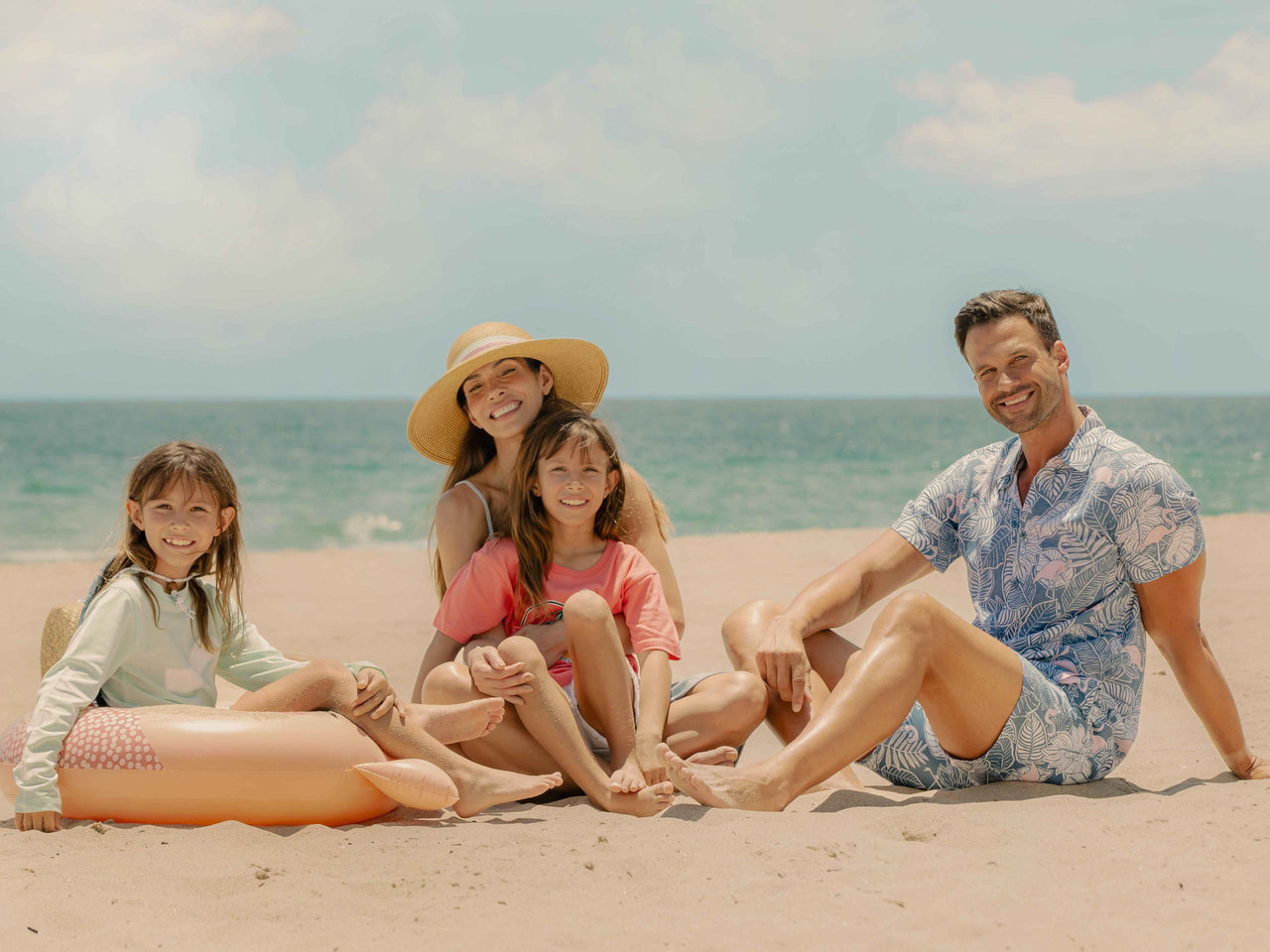 A family of four using Surf Style apparel and accessories enjoying at the beach