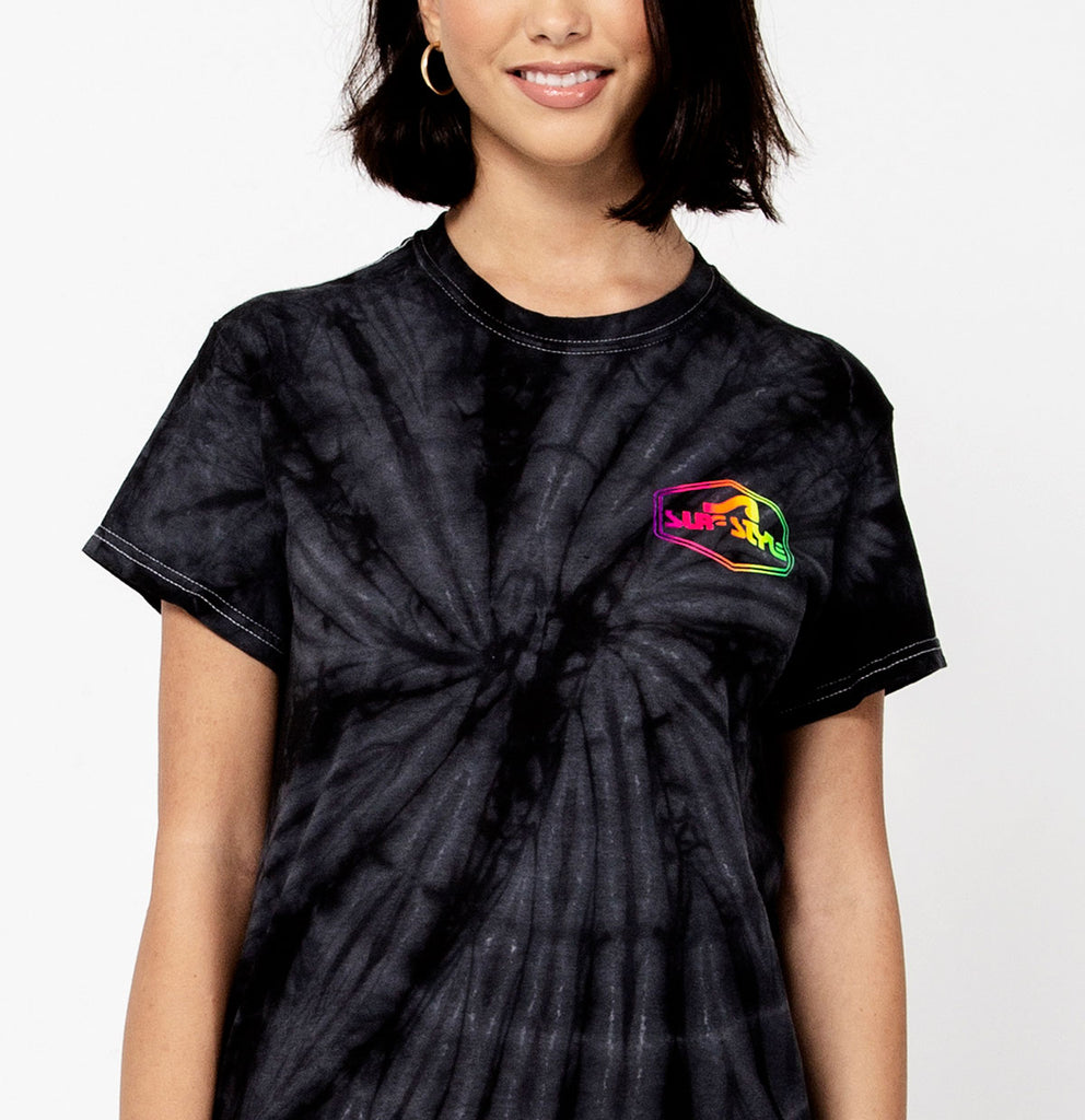 female showing the front of the Surf Style Dark Tie Dye Neon Shield Logo shirt